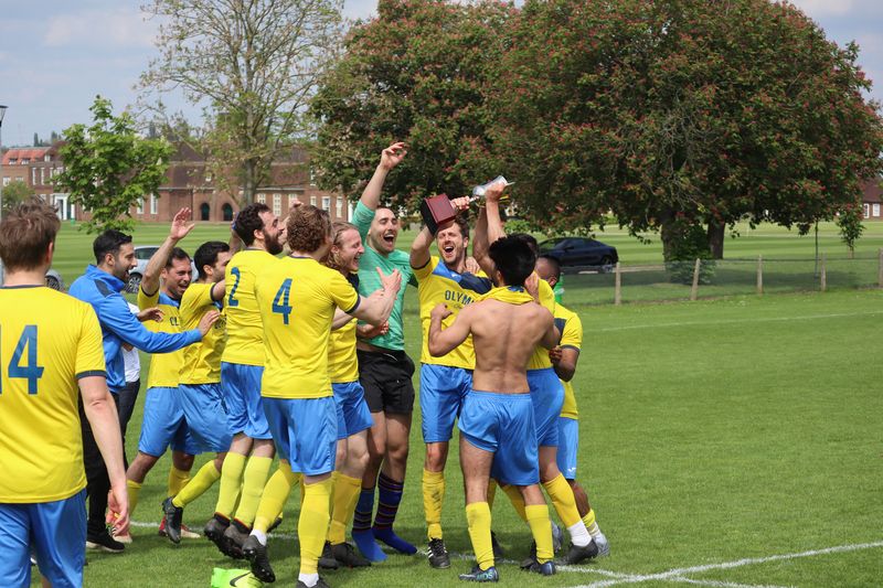 Old Albanians FC players lifting the David Woolcott Trophy